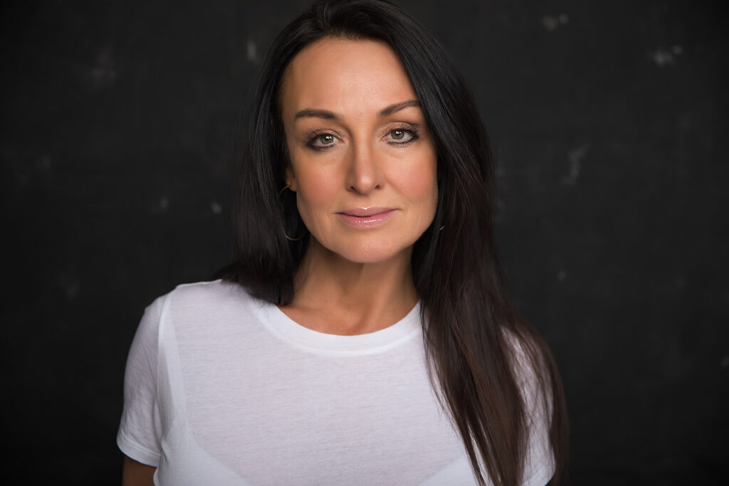 brunette with straight hair wearing white tshirt
