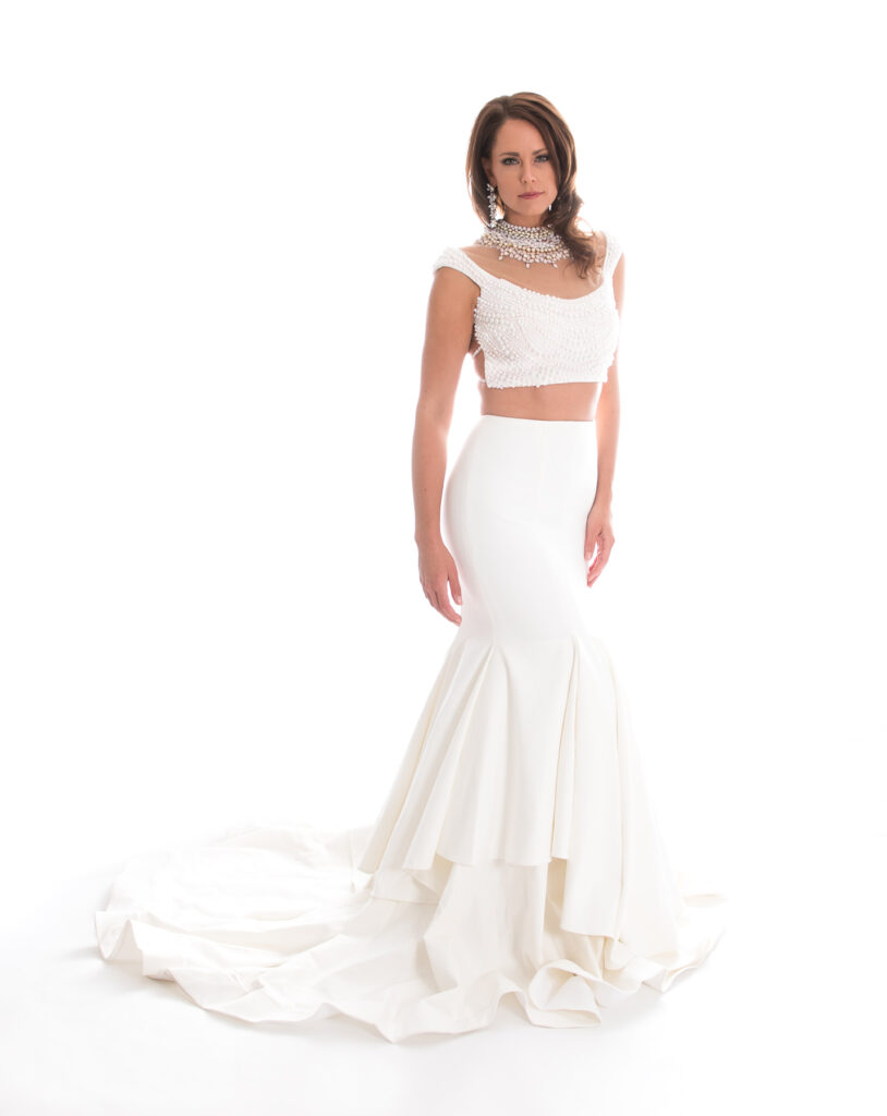brunette woman with white crop top and full ball gown skirt