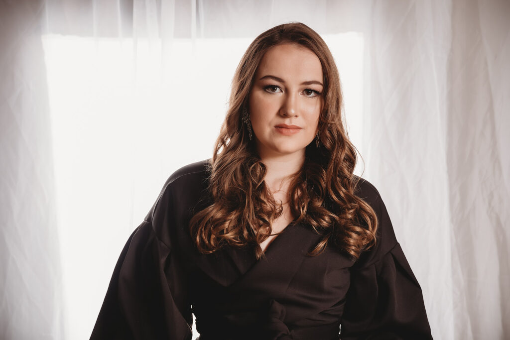 woman with long curly hair wearing black top